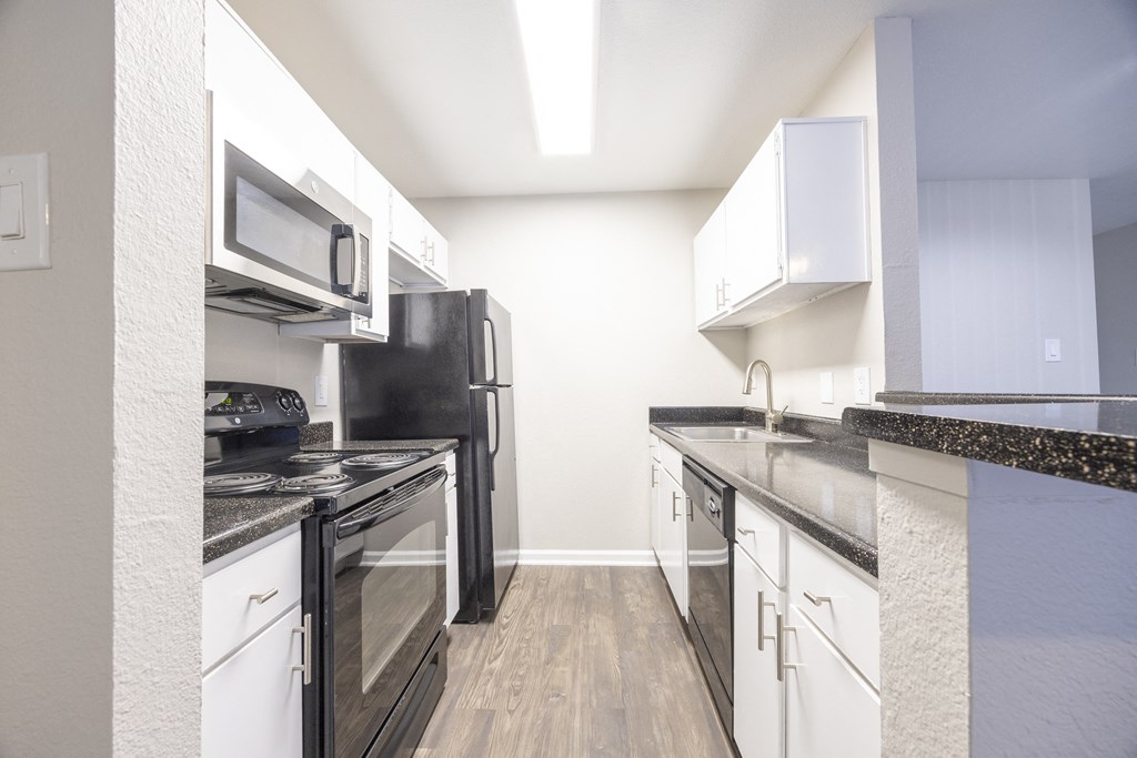 a kitchen with stainless steel appliances and white cabinets