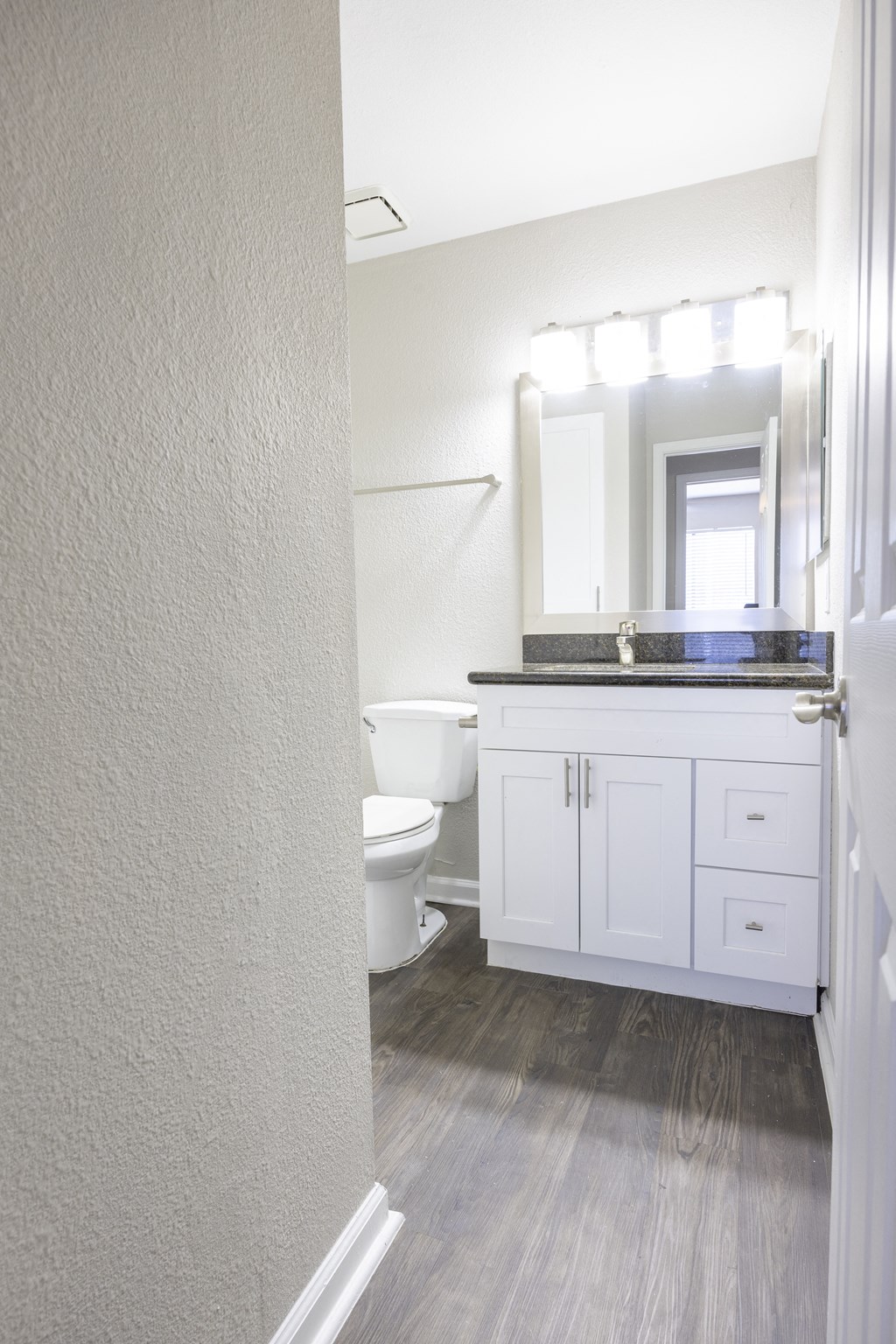 a bathroom with a toilet and a sink and a mirror