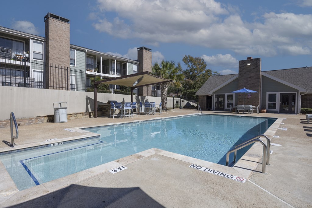 A pool with a no diving sign in the foreground.