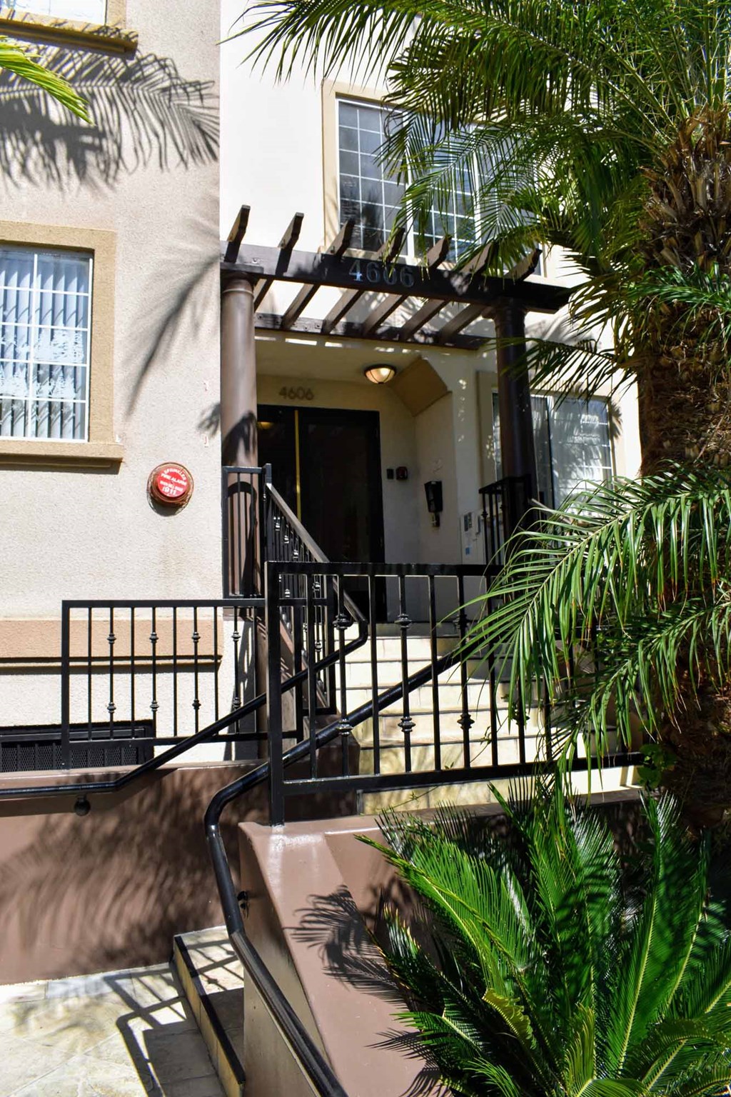 View of exterior entrance to Regency at Sherman Oaks with tropical landscaping