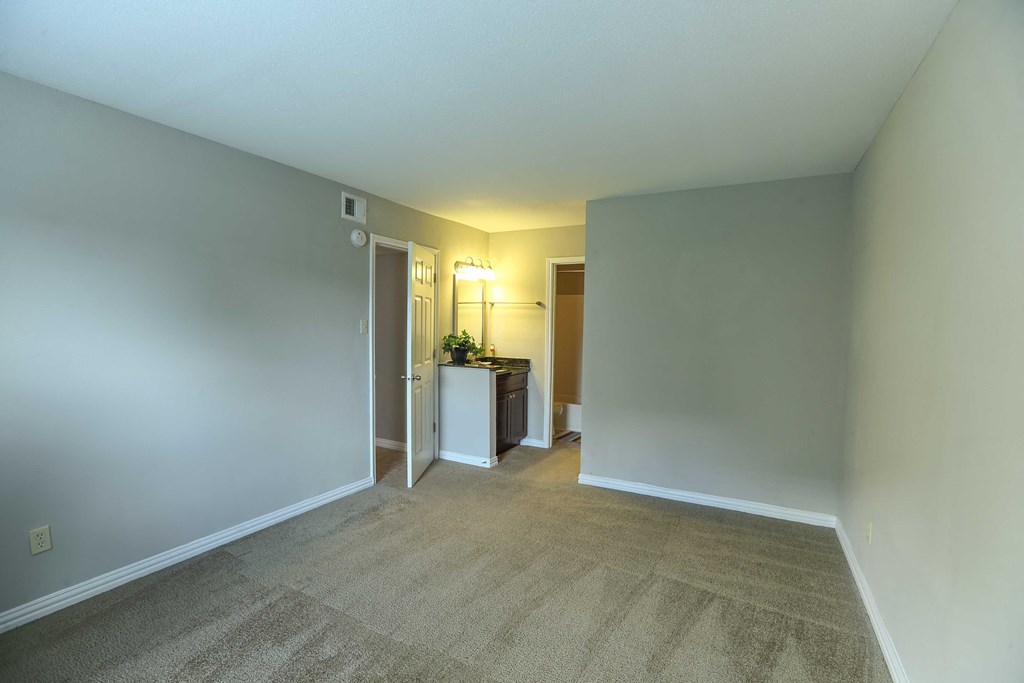 View of bedroom with carpet flooring, vanity and sink out side of bathroom - with ensuit bathroom