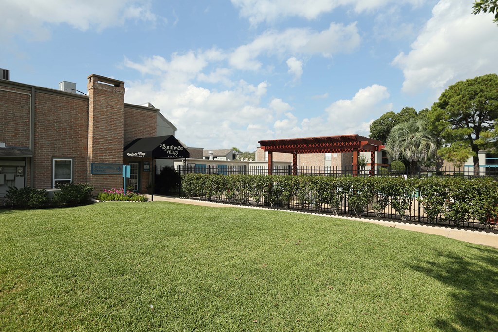 View of courtyard with gated community pool and leasing office in the background