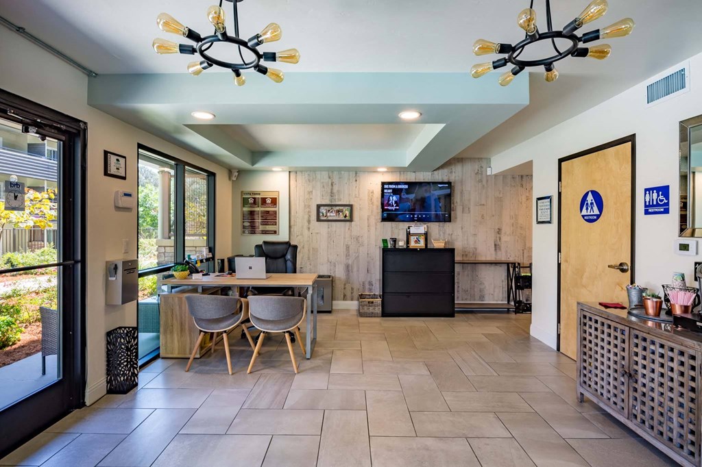 a dining room with a table and chairs and a tv