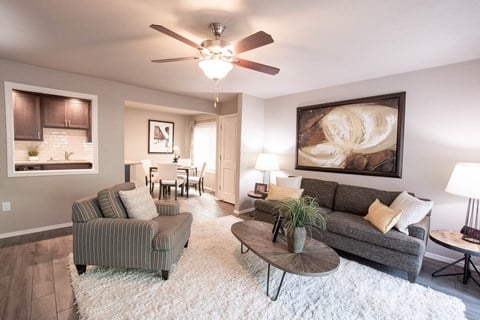 a living room with a ceiling fan and a couch