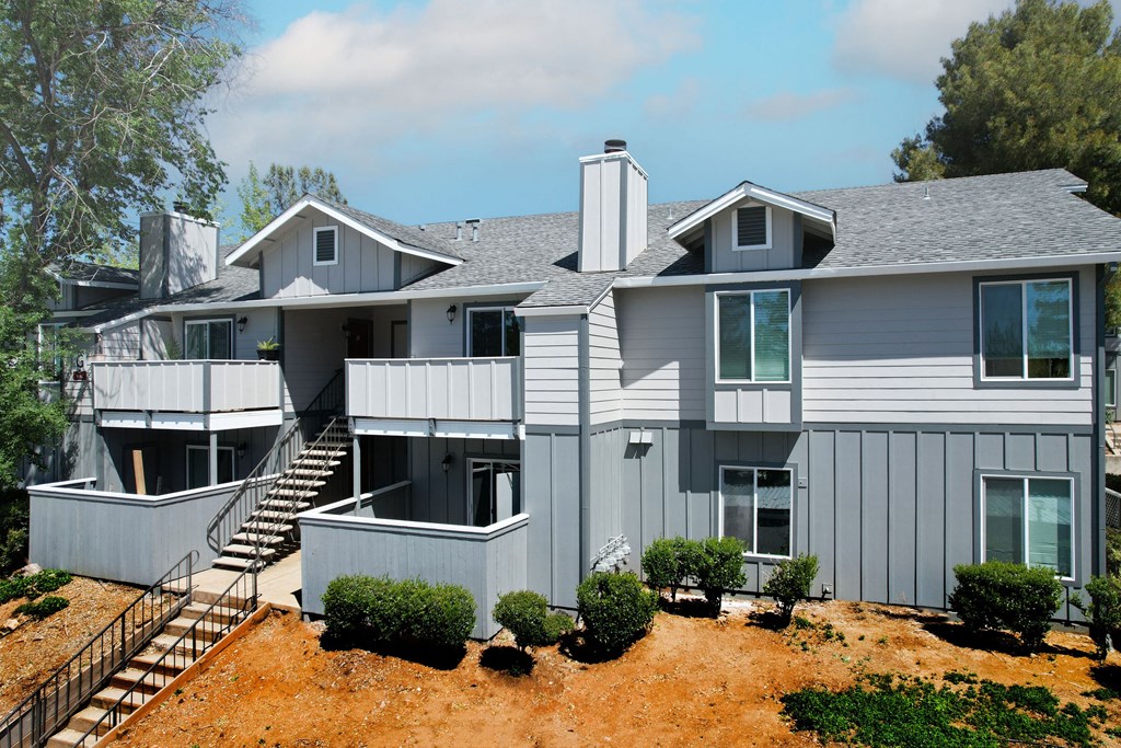 a large gray house with a gray roof