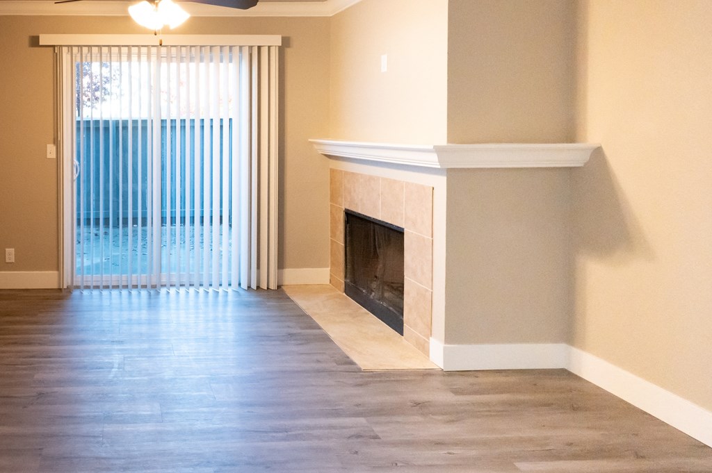 a living room with a fireplace and a window