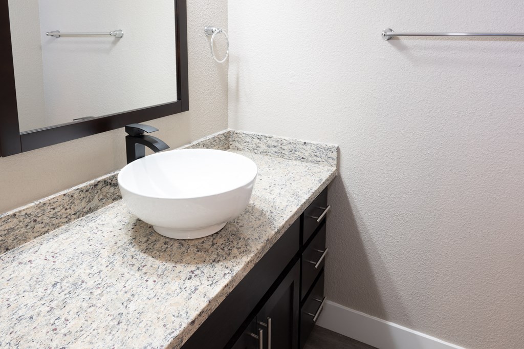 a bathroom with a bowl sink on a counter and a mirror at Sierra Oaks Living Apartments, Cameron Park, CA 95682
