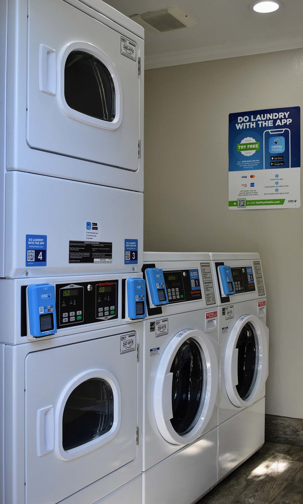 View of laundry facility with multiple washers and dryers