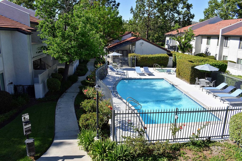 View of pools from 2nd floor featuring lounge chairs, seating area, and spa.