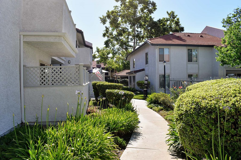 View of exterior building with sidewalk and green shrubbery