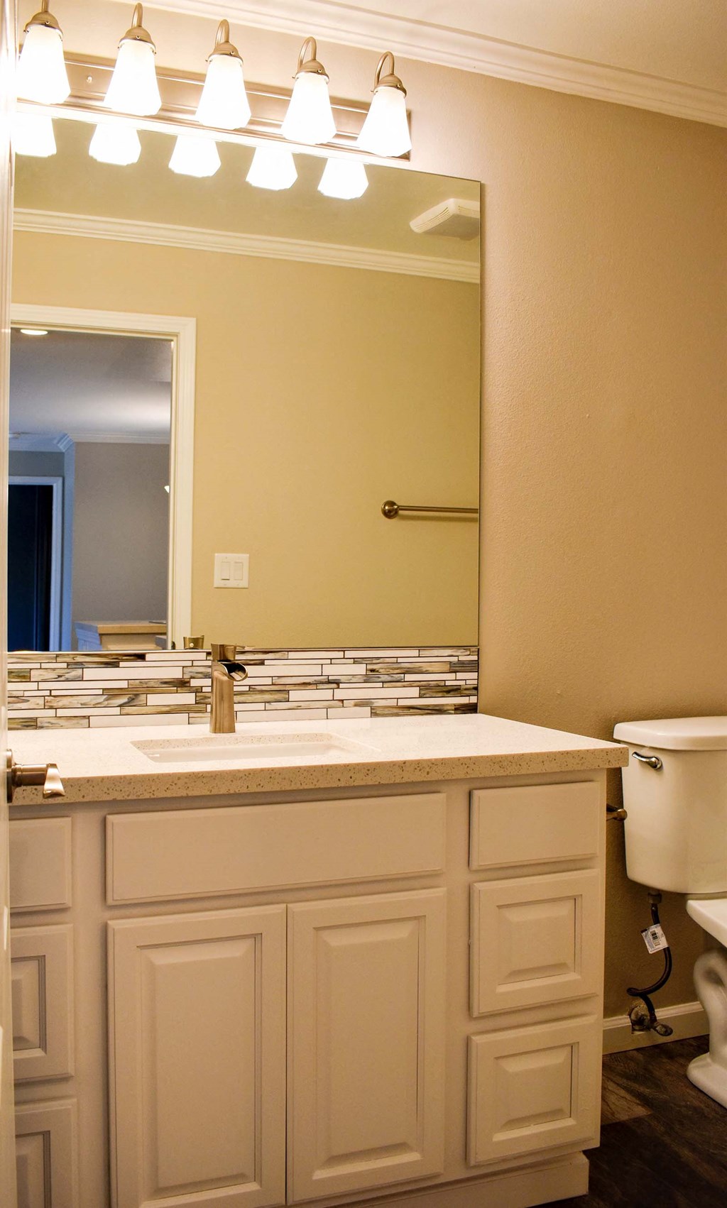 Bathroom with large mirror and storage