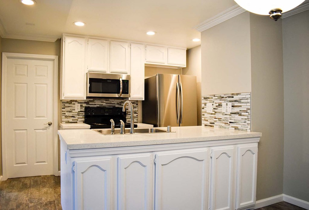 View of exterior building with sidewalk and green shrubbery