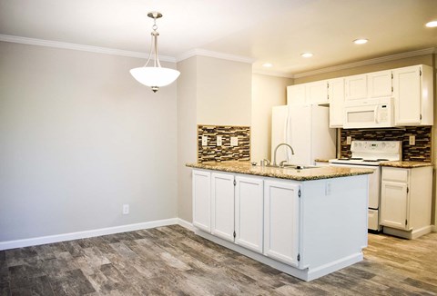 a kitchen with white cabinets and a counter top