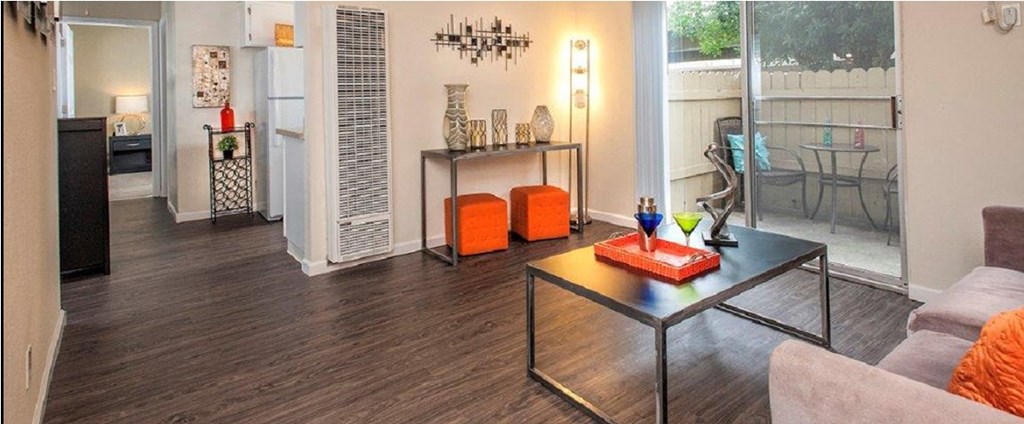 View of living area with access via sliding glass door into private patio