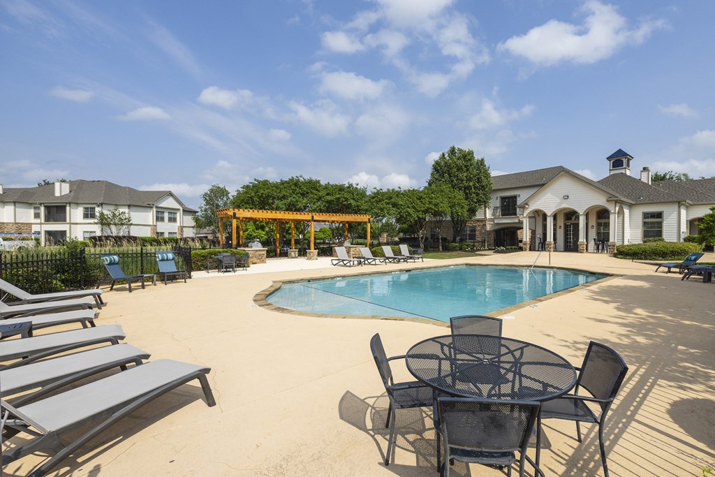our apartments offer a swimming pool with chairs and tables