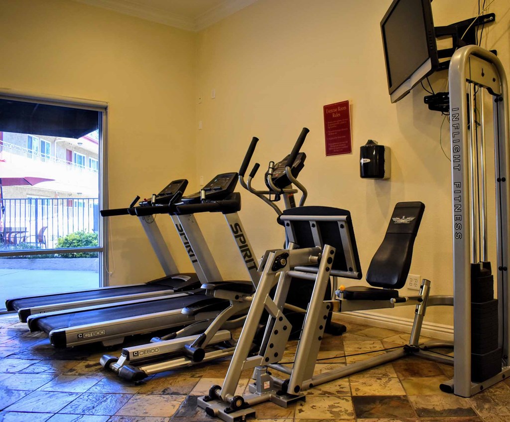 community gym with treadmill, stationary bike, and elliptical