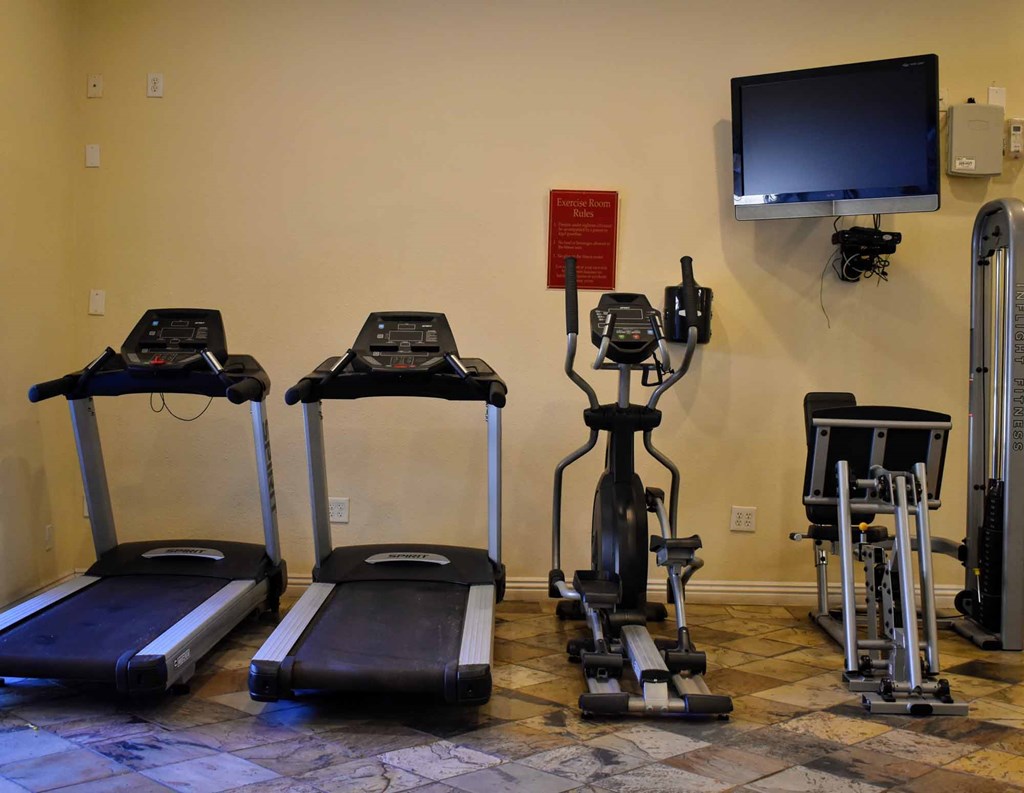community fitness center with treadmill, stationary bike, and elliptical