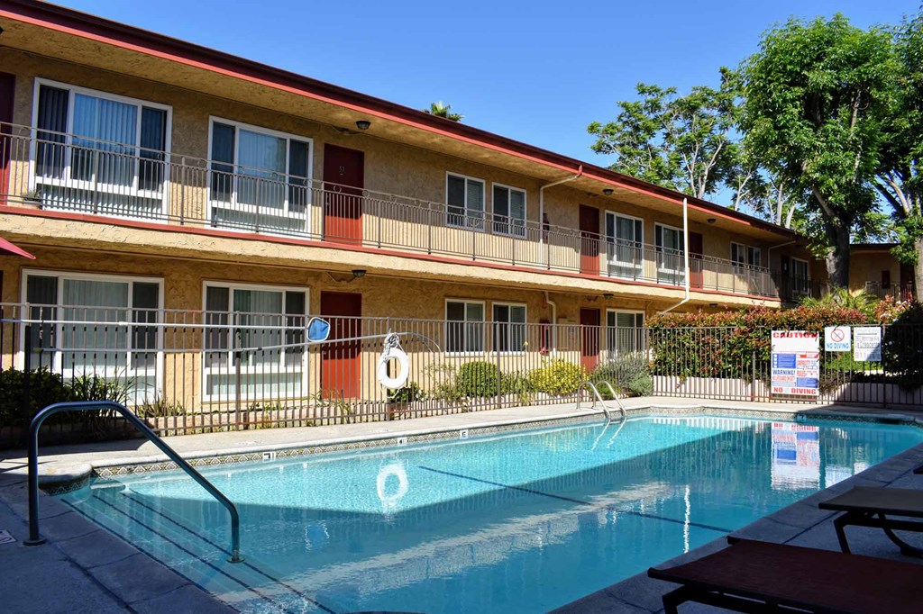 gated community pool with view of first and second story of building