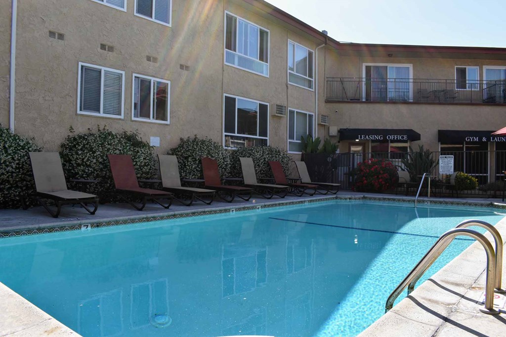 gated community pool with lounge chairs