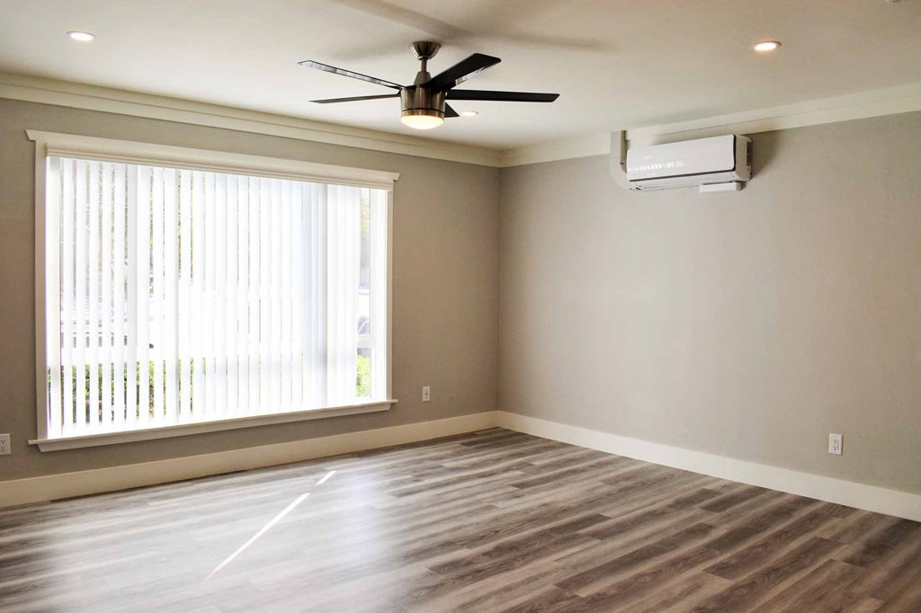 living room with wood look flooring, large floor to ceiling window, and ceiling fan