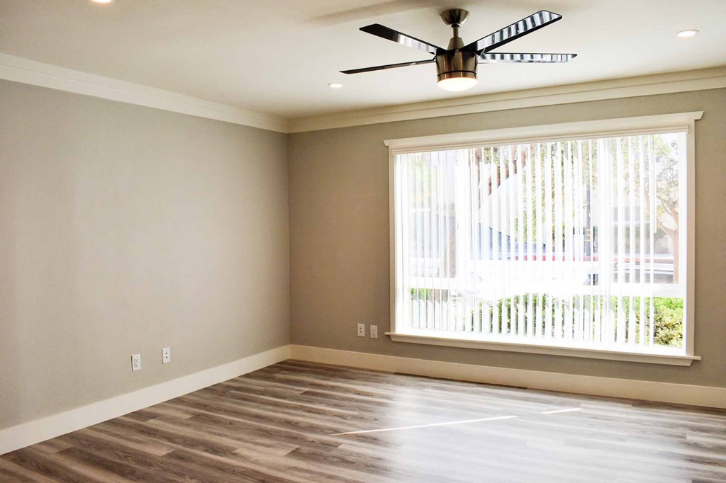 living room with wood look flooring, large floor to ceiling window, and ceiling fan