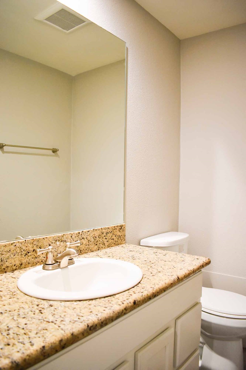 bathroom with in laid sink and large mirror