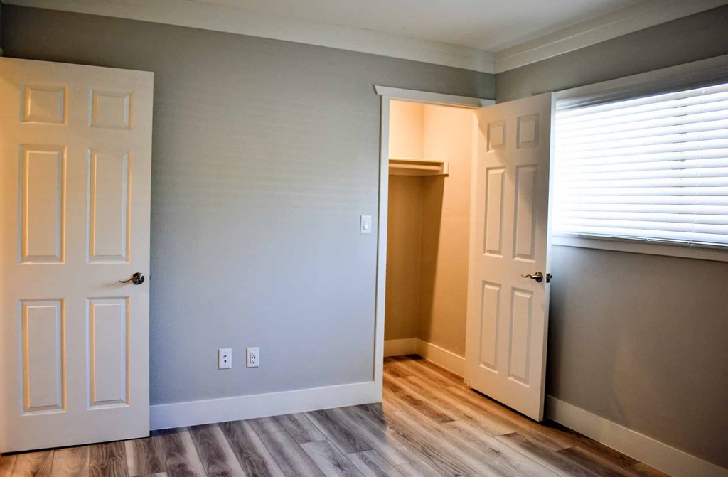 bedroom with wood look flooring and large window