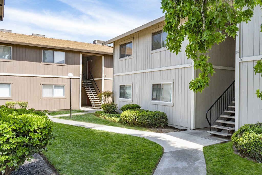 the outlook of a building with stairs and a sidewalk