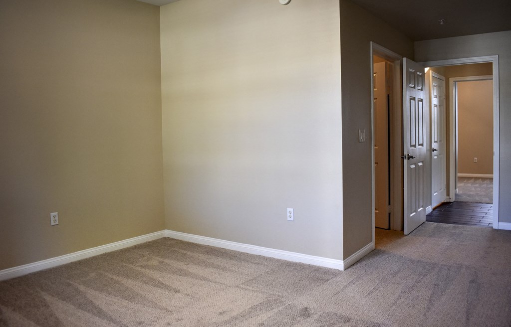view of bedroom and hallway leading to second bedroom