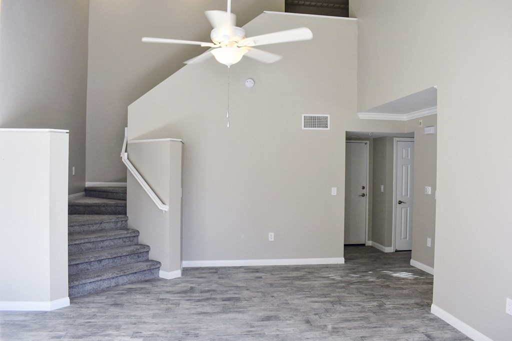 living room with stairs leading  to bedroom