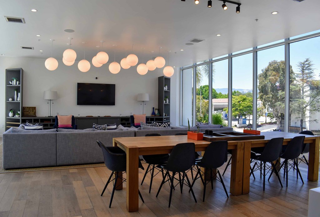 a dining room with a table and chairs and a living room