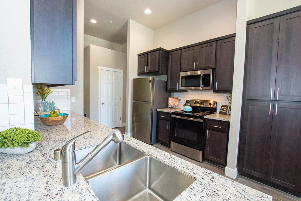 a kitchen with stainless steel appliances and granite counter tops