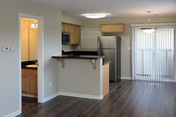view from living room into kitchen showing wood floors