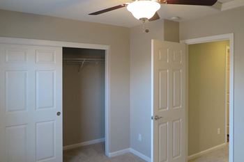 View of bedroom with ceiling fan  and closet