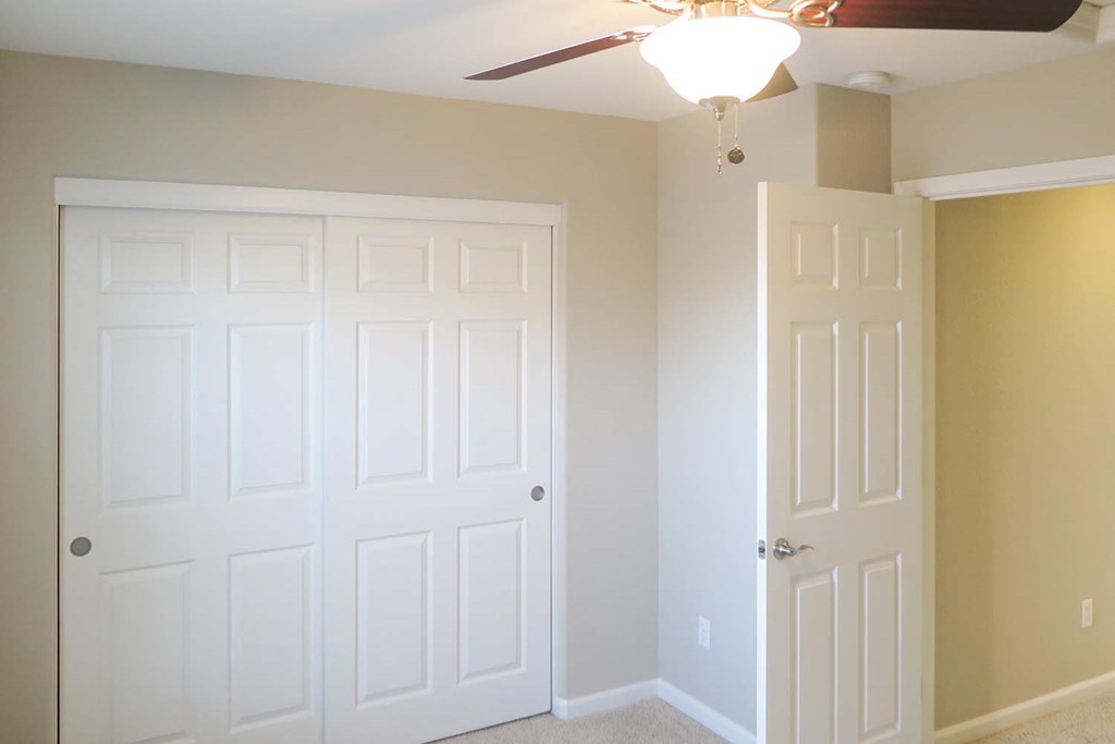View of bedroom with ceiling fan  and closet