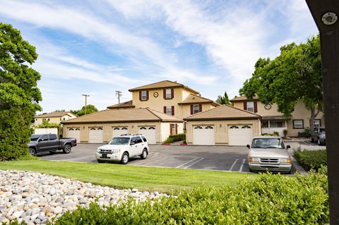 abuilding at Tuscana with two garages and two cars parked in the driveway