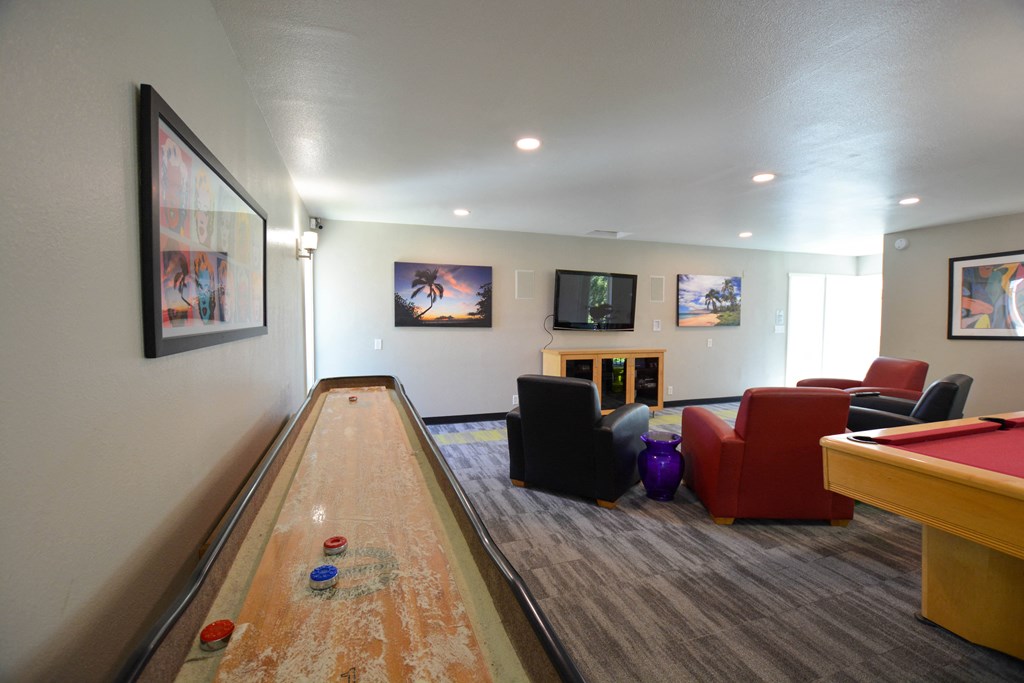 a game room with a bowling alley and a pool table