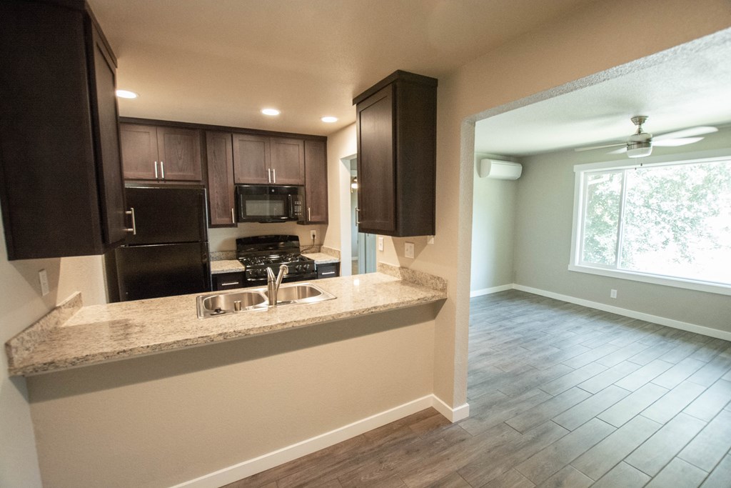 a kitchen with a large window and a counter with a sink