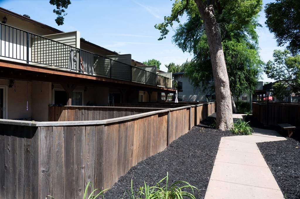 View of private patio/balcony and sidewalk winding through