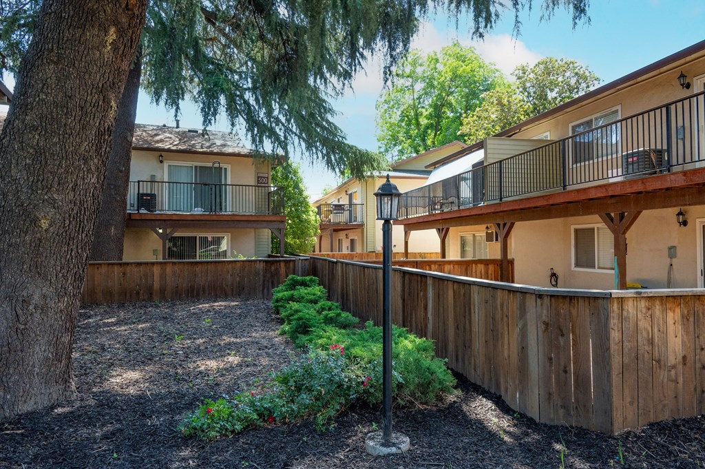 View of private patio/balcony and trees providing shade