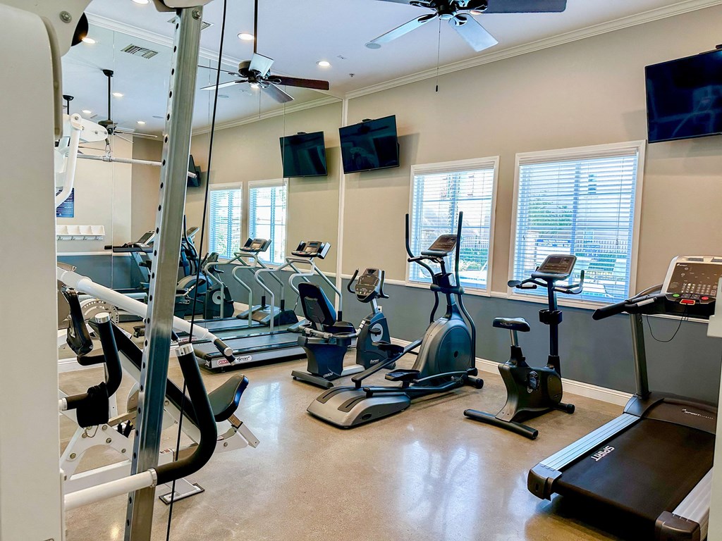a gym with treadmills and other exercise equipment