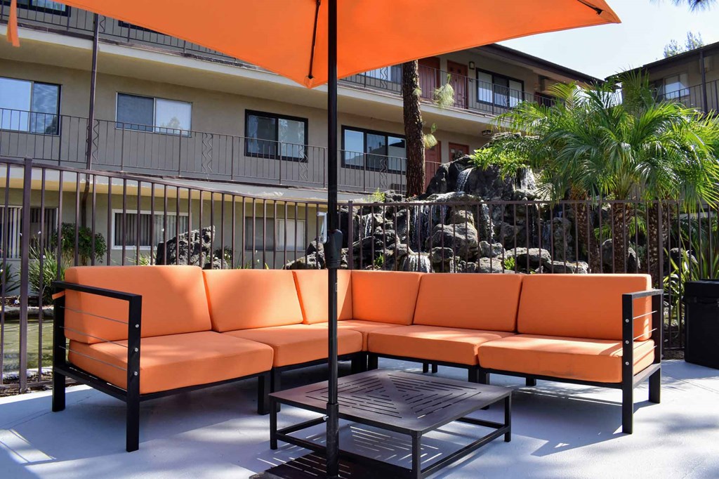 a patio with orange couches