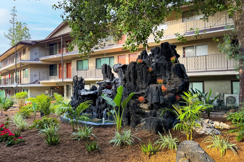 a building with a rock sculpture in the front of it