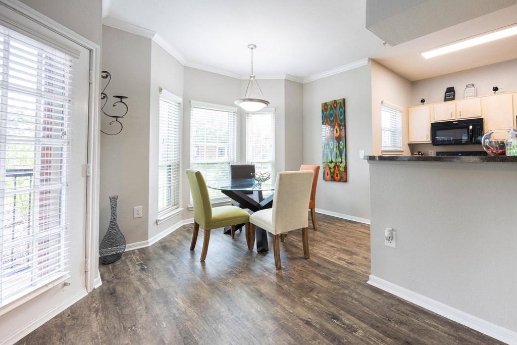 a dining room with a table and chairs and a window