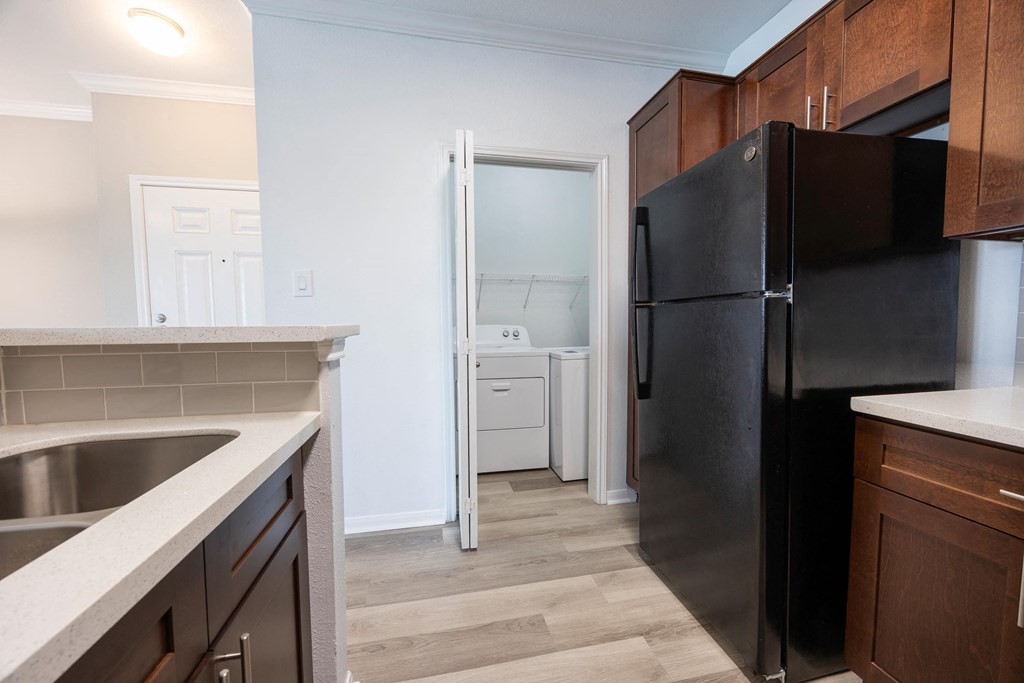 a kitchen with black appliances and a black refrigerator