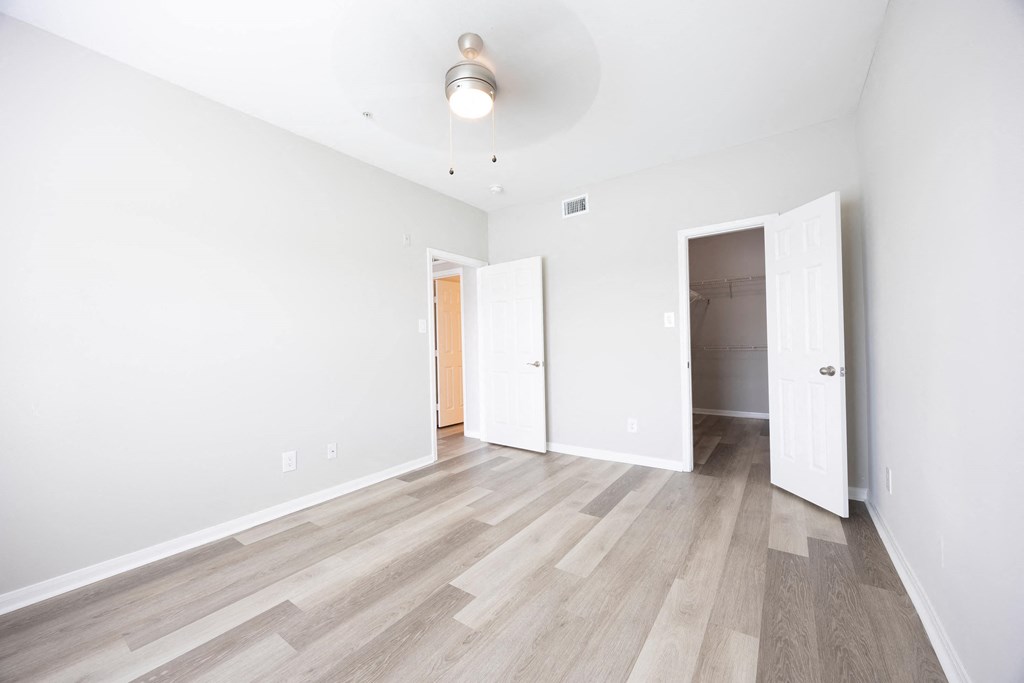 a living room with white walls and wood floors