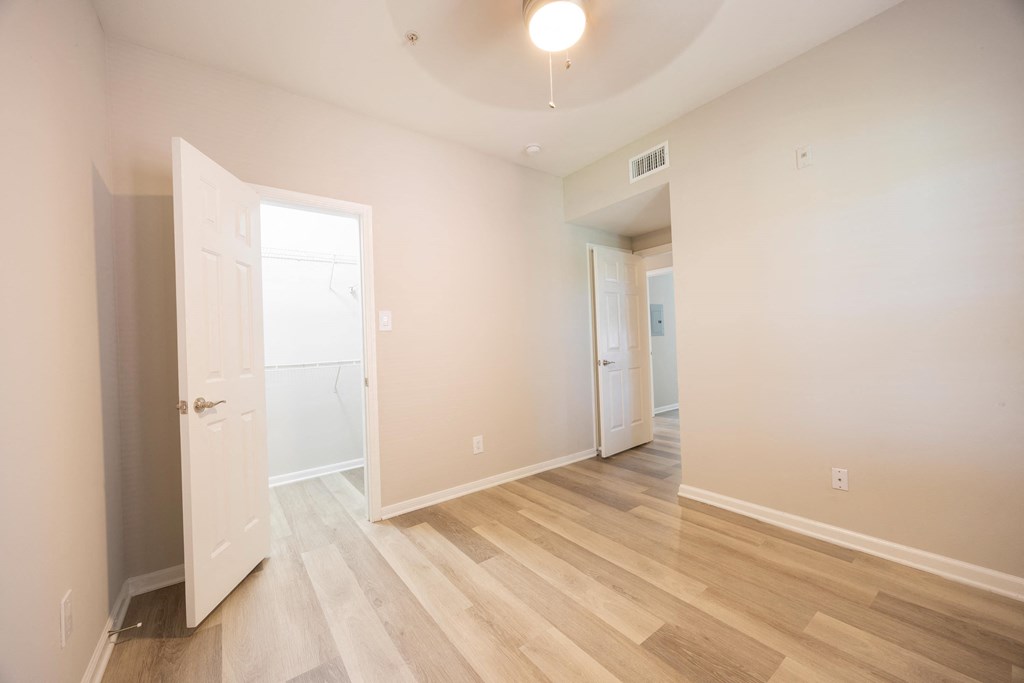 a living room with white walls and wood floors