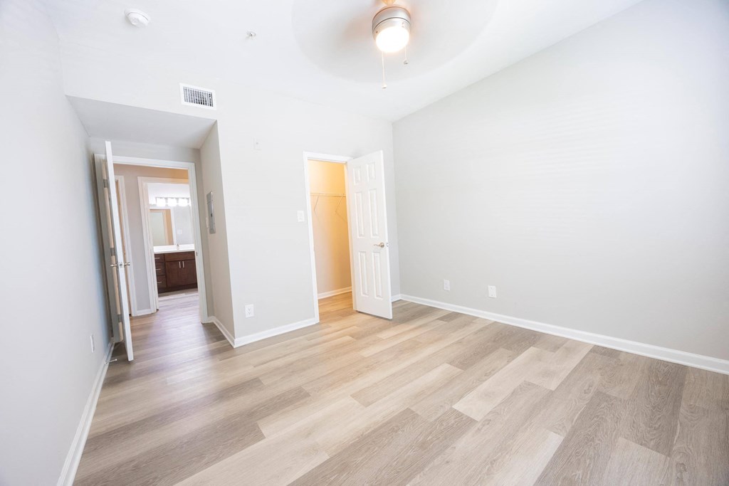 a room with a hard wood floor and white walls