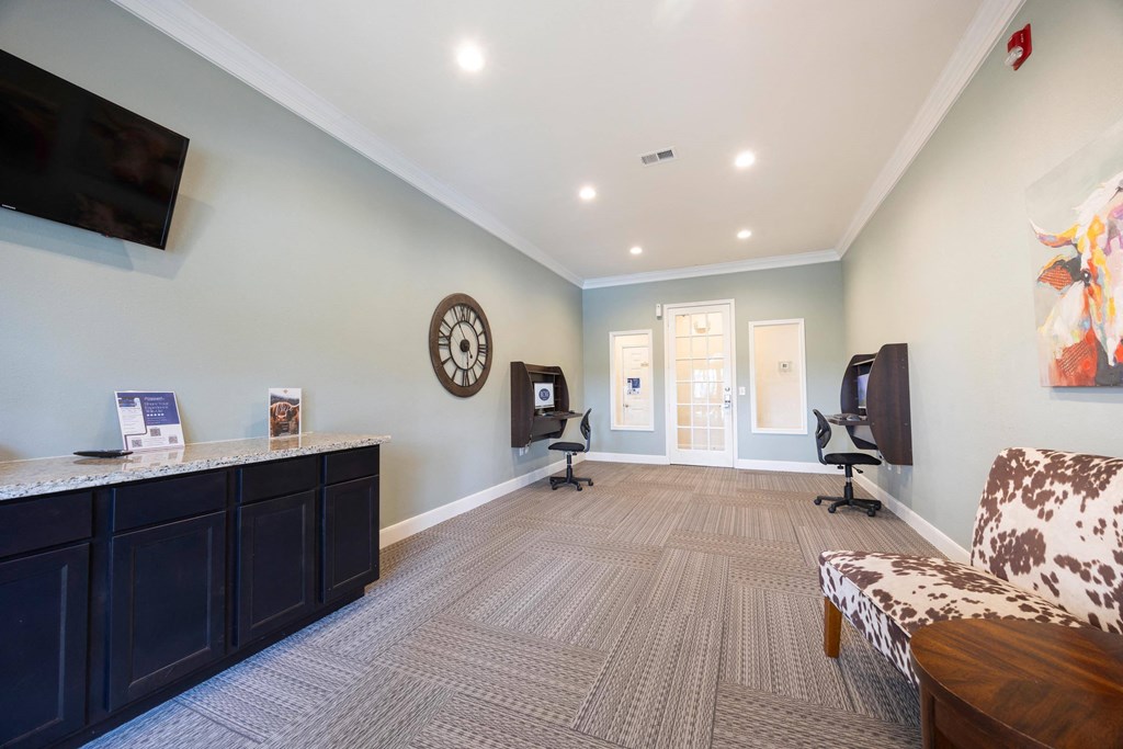 a living room with a couch and a desk with a tv