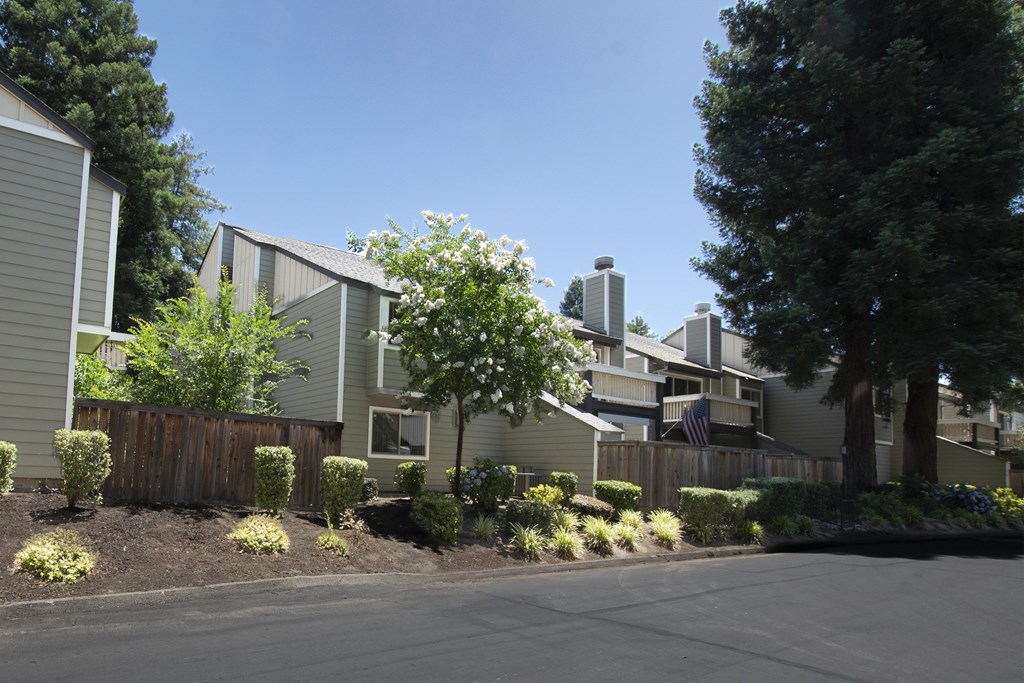 A row of houses with a clear blue sky above them.